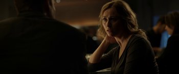 Movie still from “Department Q: The Keeper of Lost Causes” (2013), directed by Mikkel Nørgaard – A woman sitting in front of a man at a table; Close Up shot, Over the shoulder angle