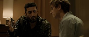 Movie still from “Department Q: The Keeper of Lost Causes” (2013), directed by Mikkel Nørgaard – A man and a boy are talking to each other; Close Up shot, Over the shoulder angle