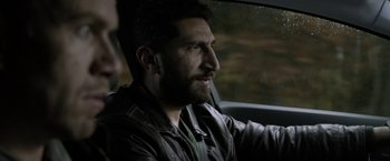Movie still from “Department Q: The Keeper of Lost Causes” (2013), directed by Mikkel Nørgaard – A man with a beard is sitting in a car; Close Up shot, Over the shoulder angle