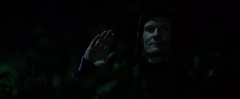 Movie still from “Department Q: The Keeper of Lost Causes” (2013), directed by Mikkel Nørgaard – A man in a dark room with his hand raised; Close Up shot, Low angle