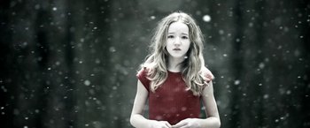 Movie still from “Department Q: The Keeper of Lost Causes” (2013), directed by Mikkel Nørgaard – A young girl in a red dress standing in the snow; Medium shot, Low angle