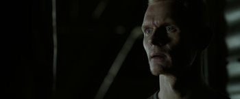 Movie still from “Department Q: The Keeper of Lost Causes” (2013), directed by Mikkel Nørgaard – A person looking at the camera; Close Up shot, Low angle