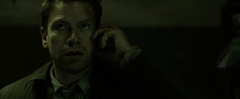 Movie still from “Department Q: The Keeper of Lost Causes” (2013), directed by Mikkel Nørgaard – A person talking on a cell phone; Close Up shot, Low angle