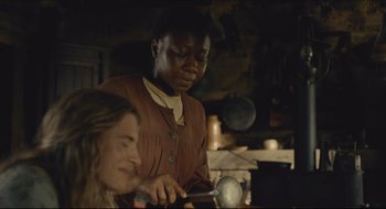 Movie still from “The Keeping Room” (2014), directed by Daniel Barber – Two women are working in a kitchen together; Medium shot, High angle