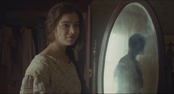 Movie still from “The Keeping Room” (2014), directed by Daniel Barber – A young woman standing in front of a mirror; Close Up shot, Over the shoulder angle