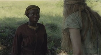 Movie still from “The Keeping Room” (2014), directed by Daniel Barber – Two women standing next to each other in a field; Medium shot, Over the shoulder angle