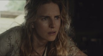 Movie still from “The Keeping Room” (2014), directed by Daniel Barber – A person with long blonde hair; Close Up shot, Over the shoulder angle