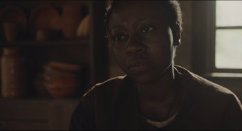 Movie still from “The Keeping Room” (2014), directed by Daniel Barber – A person wearing a brown shirt; Close Up shot, Over the shoulder angle