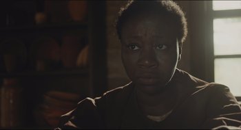Movie still from “The Keeping Room” (2014), directed by Daniel Barber – A woman with a serious look on her face; Close Up shot, High angle