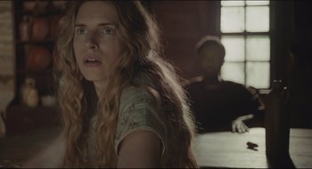 Movie still from “The Keeping Room” (2014), directed by Daniel Barber – A woman with long blonde hair sitting in front of a man; Close Up shot, Over the shoulder angle