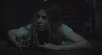 Movie still from “The Keeping Room” (2014), directed by Daniel Barber – A woman laying on the ground in a dark room; Close Up shot, High angle