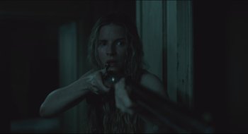 Movie still from “The Keeping Room” (2014), directed by Daniel Barber – A woman is holding a knife in her mouth; Close Up shot, Over the shoulder angle