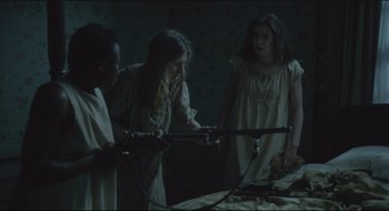 Movie still from “The Keeping Room” (2014), directed by Daniel Barber – A group of young girls in a dark room; Medium shot, High angle