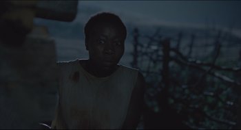 Movie still from “The Keeping Room” (2014), directed by Daniel Barber – A man with a blood covered face standing in the dark; Close Up shot, High angle