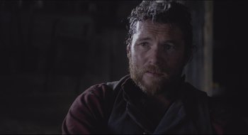 Movie still from “The Keeping Room” (2014), directed by Daniel Barber – A man with a beard is looking at the camera; Close Up shot, Over the shoulder angle