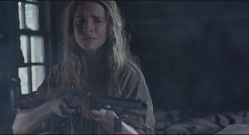 Movie still from “The Keeping Room” (2014), directed by Daniel Barber – A woman holding a gun in her hands; Close Up shot, Low angle