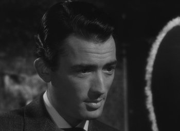Movie still from “The Keys of the Kingdom” (1944), directed by John M. Stahl – Black and white photograph of a man in a suit and tie; Close Up shot, Over the shoulder angle