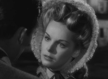 Movie still from “The Keys of the Kingdom” (1944), directed by John M. Stahl – A black and white photo of a woman in a hat; Close Up shot, Over the shoulder angle