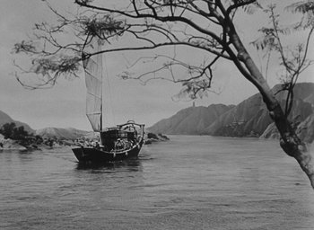 Movie still from “The Keys of the Kingdom” (1944), directed by John M. Stahl – A boat floating on top of a body of water near a tree; Extreme Wide shot, High angle