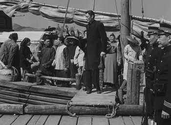 Movie still from “The Keys of the Kingdom” (1944), directed by John M. Stahl – An old black and white photo of people on a boat; Wide shot, High angle