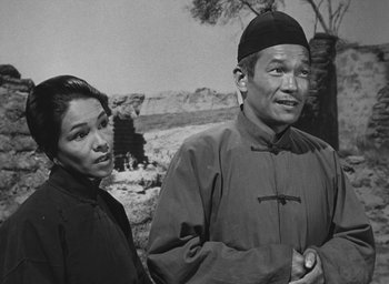 Movie still from “The Keys of the Kingdom” (1944), directed by John M. Stahl – An older man and a younger woman standing next to each other; Medium shot, Over the shoulder angle