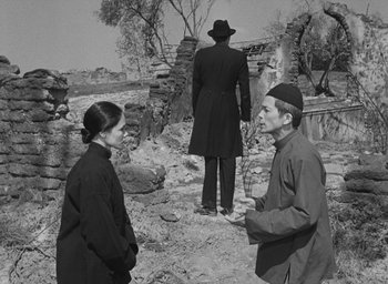 Movie still from “The Keys of the Kingdom” (1944), directed by John M. Stahl – A man and a woman standing in front of an older man; Medium shot, Over the shoulder angle
