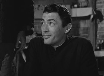 Movie still from “The Keys of the Kingdom” (1944), directed by John M. Stahl – Black and white photograph of a man looking at the camera; Close Up shot, Over the shoulder angle