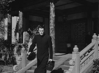 Movie still from “The Keys of the Kingdom” (1944), directed by John M. Stahl – A man walking down the steps of a building; Medium shot, Low angle