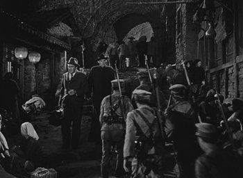 Movie still from “The Keys of the Kingdom” (1944), directed by John M. Stahl – A black and white photo of a group of men in uniform; Wide shot, High angle