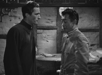 Movie still from “The Keys of the Kingdom” (1944), directed by John M. Stahl – A man and a man standing next to each other; Medium shot, Over the shoulder angle