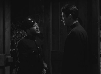 Movie still from “The Keys of the Kingdom” (1944), directed by John M. Stahl – A black and white photo of two men talking to each other; Medium shot, Over the shoulder angle