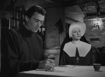 Movie still from “The Keys of the Kingdom” (1944), directed by John M. Stahl – A man and a woman are sitting at a table; Medium shot, Low angle