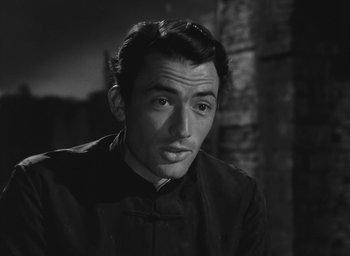 Movie still from “The Keys of the Kingdom” (1944), directed by John M. Stahl – Black and white photograph of a man in a black shirt; Close Up shot, Over the shoulder angle