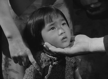 Movie still from “The Keys of the Kingdom” (1944), directed by John M. Stahl – A little girl being held up by a person; Close Up shot, High angle
