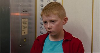 Movie still from “The Kid with a Bike” (2011), directed by Jean-Pierre Dardenne – A young boy in a blue shirt and a red jacket; Close Up shot, Low angle