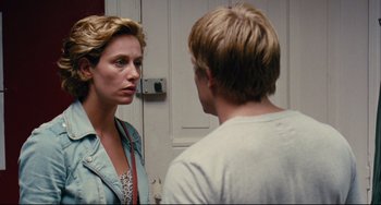 Movie still from “The Kid with a Bike” (2011), directed by Jean-Pierre Dardenne – A woman standing next to a man in front of a white door; Close Up shot, Over the shoulder angle