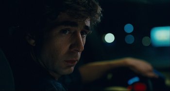 Movie still from “The Kid with a Bike” (2011), directed by Jean-Pierre Dardenne – A person sitting in a car at night; Close Up shot, Over the shoulder angle