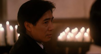 Movie still from “The Killer” (1989), directed by John Woo – A person wearing a suit and tie; Close Up shot, Low angle