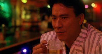 Movie still from “The Killer” (1989), directed by John Woo – A person holding a cup of beer; Close Up shot, Low angle