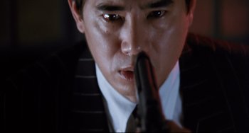 Movie still from “The Killer” (1989), directed by John Woo – A person holding a gun in their hand; Extreme Close Up shot, Low angle