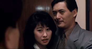Movie still from “The Killer” (1989), directed by John Woo – A man and a woman standing next to each other; Close Up shot, High angle