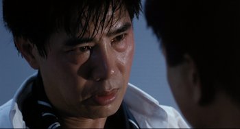 Movie still from “The Killer” (1989), directed by John Woo – A person with a nose ring; Close Up shot, Low angle