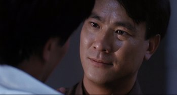 Movie still from “The Killer” (1989), directed by John Woo – A man's eyes and face; Close Up shot, Over the shoulder angle