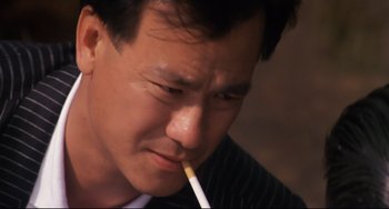Movie still from “The Killer” (1989), directed by John Woo – A person holding a cigarette in his mouth; Close Up shot, Low angle