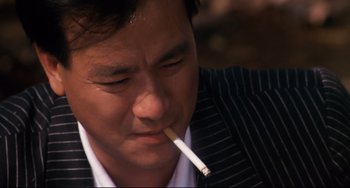Movie still from “The Killer” (1989), directed by John Woo – A person with a cigarette in his mouth; Close Up shot, Low angle