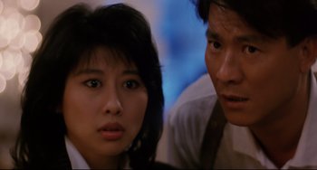 Movie still from “The Killer” (1989), directed by John Woo – A man and a woman looking at each other; Close Up shot, Over the shoulder angle