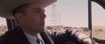 Movie still from “The Killer Inside Me” (2010), directed by Michael Winterbottom – A man wearing a cowboy hat driving a car; Close Up shot, Over the shoulder angle