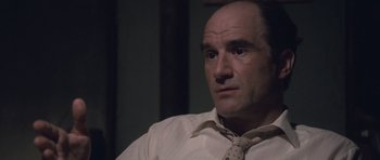 Movie still from “The Killer Inside Me” (2010), directed by Michael Winterbottom – A man in a white dress shirt and a tie; Close Up shot, Over the shoulder angle