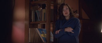 Movie still from “The Killer Inside Me” (2010), directed by Michael Winterbottom – A woman standing in front of a bookcase; Medium shot, Over the shoulder angle