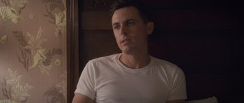 Movie still from “The Killer Inside Me” (2010), directed by Michael Winterbottom – A man in a white shirt is looking at the camera; Close Up shot, Low angle